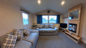 Living room has two large sofas, fireplace and TV with use of firestick. Internet is included within your stay free of charge