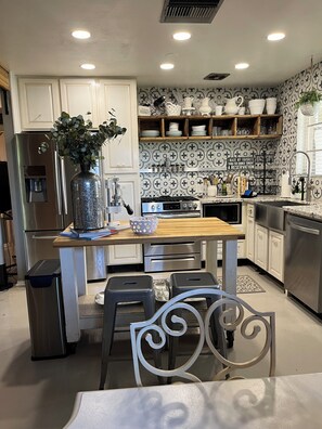 Fully stocked kitchen with gas stove. View from dining room..