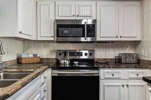 Fully equipped kitchen features stainless appliances