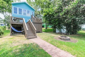Backyard with hammock and firepit. Lots of lawn chairs available. 