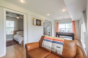 Downstairs game room with foosball, darts, TV, and lake views! 
