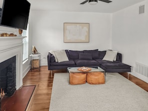 Living room hosts a large size TV. Fireplace is NON-working.
