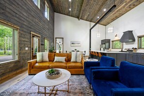 Entertain in Grandeur: Open-concept living room, dining, and kitchen area are perfect for family fun