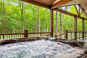 Bubbles, trees, and a gentle breeze – our hot tub offers the perfect spot to unwind and recharge after a day of adventures.