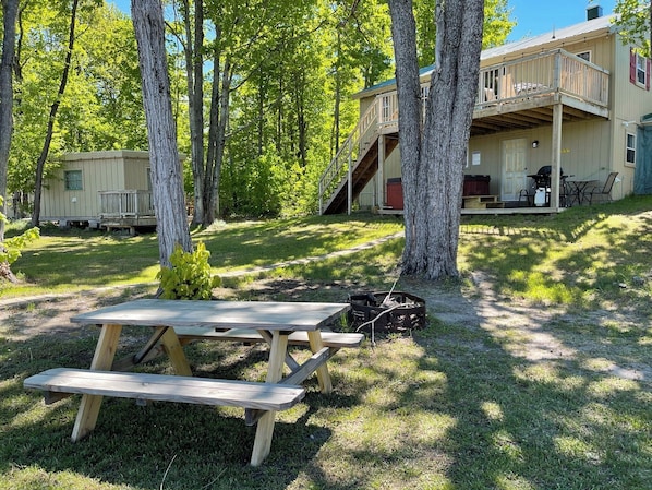 Fire pit area and backyard showing bunkhouse on the left