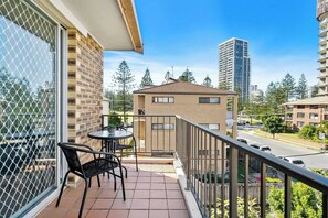 The balcony is furnished with a charming table and two chairs, ideal for enjoying your morning brew and watching the soaring skyline. 
