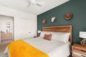 2nd bedroom with king size bed, pool view, ceiling fan, walk-in closet, smart TV and adjacent bathroom
