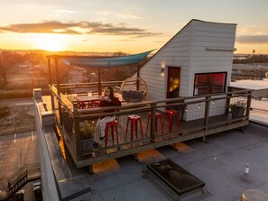 Private rooftop deck—sunset views, string lights, and celebration-ready.