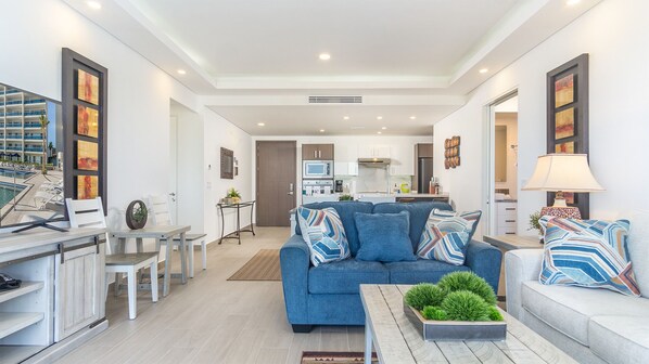 The living room flows past the dining room to the kitchen