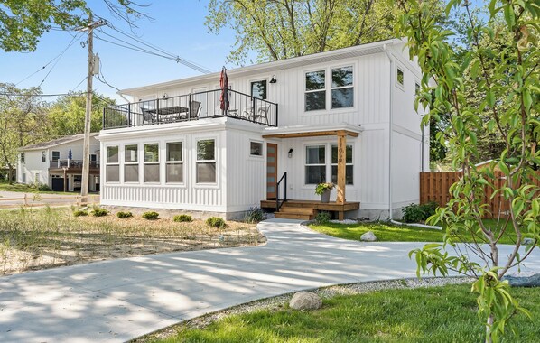 Front exterior of cottage with rooftop deck