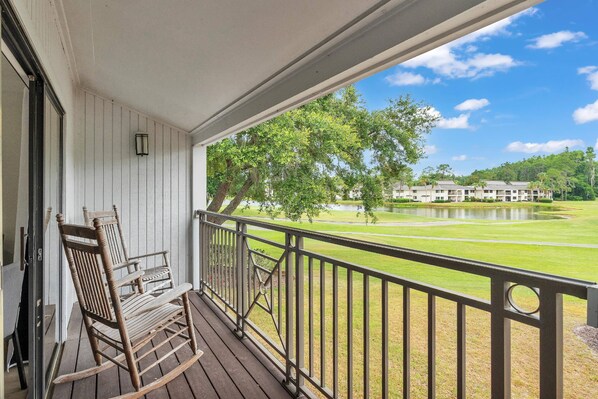 Rocking chairs gently swaying while facing the perfect view of the lush golf course