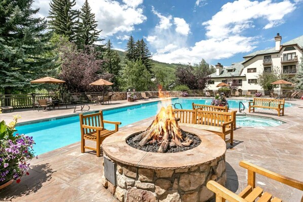 Enjoy the gorgeous outdoor pool with fire pit and mountain views.