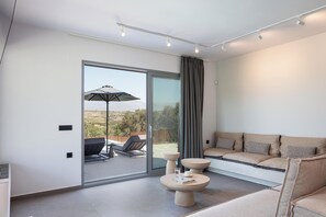 The living room area is located on the ground floor with direct outdoor access