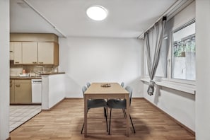 A 5 seater dining table by the window