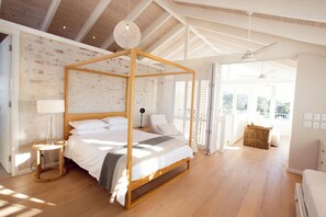 Master bedroom with four paster bed. Ceiling fans