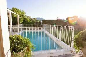 Crystal clear pool with surrounding fence and child lock
