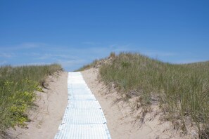 Walk to the beach from the back of the home