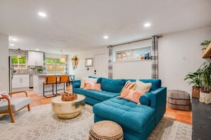 Fully furnished and expertly designed lounge space with large smart TV and lots of natural sunlight or room-darkening shades, to fit anyone's needs. The couch folds into a queen bed for two additional guests!