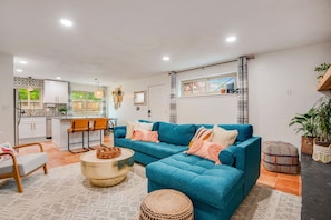 Fully furnished and expertly designed lounge space with large smart TV and lots of natural sunlight or room-darkening shades, to fit anyone's needs. The couch folds into a queen bed for two additional guests!