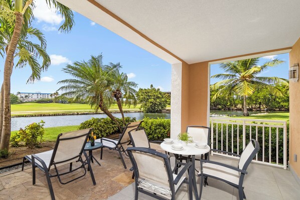 Step out from this first-floor condo onto your private patio, where the grass meets the tranquil waters of the lake, offering a serene escape right at your doorstep