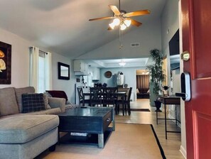 Spacious living area with raised ceiling.