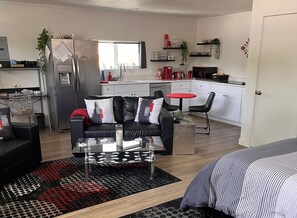 Kitchenette with stove, microwave, coffee maker, toaster, blender and frig