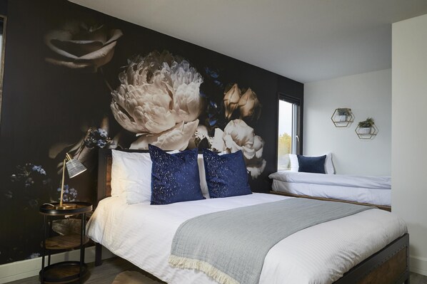 The West Rose Suite features space for 3 people to sleep comfortably on the queen-sized bed and twin bed. You'll enjoy modern touches throughout the space.