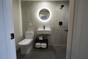 The West Rose features a modern, open, European-style washroom with large tiling throughout