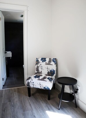 More seating with a charging station on the side table in the East Rose Suite.