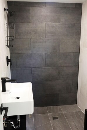 Large, modern, European-style washroom within the East Rose Suite.