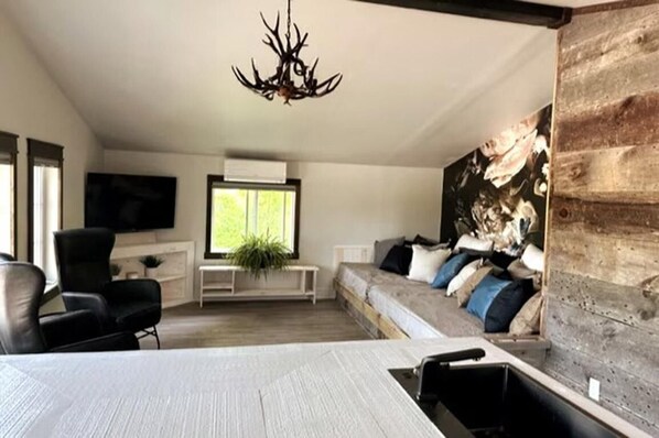Unwind in the inviting ambiance of our living room, where you can luxuriate in pure comfort while indulging in your favorite television shows or movies.