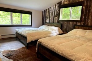 Enjoy a rejuvenating stay in our spacious bedroom, featuring two comfortable queen-size beds.
