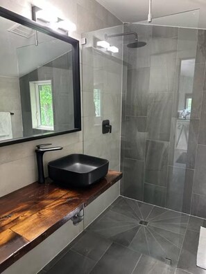 Experience pure indulgence in our meticulously designed bathroom, where every detail has been carefully crafted to provide ultimate comfort.