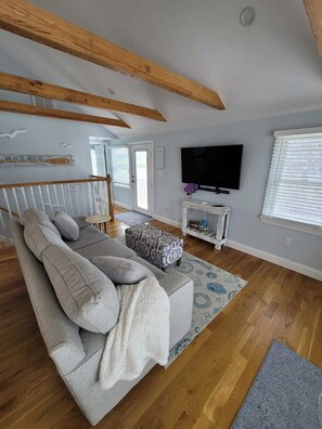 Cozy living area with river views & large TV.