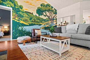 Living room with a hand painted mural.