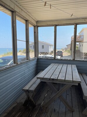 Picnic table located inside the screened in porch.