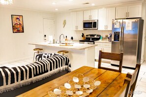 Capture the essence of comfort and convenience in our stylish living and dining room, seamlessly connected to a fully equipped kitchen.