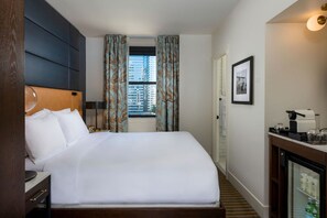 Crisp white linens and ample natural light for a peaceful and refreshing bedroom space.