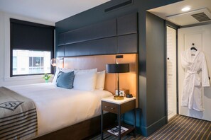 Comfort meets sleek design in this bedroom, where every detail caters to a relaxing retreat.