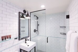 Step into a refreshing oasis with this bathroom's clean lines, monochrome palette, and premium fixtures.