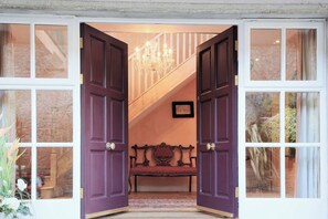 Double doors give way to a double height entrance hall 