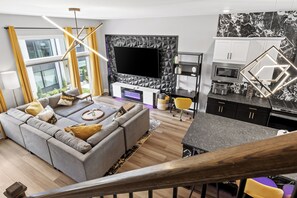 Cozy up in the stylish living room with a view of the walkway to the on-site dog park. Great for people watching, movie night, or curling up with a good book.