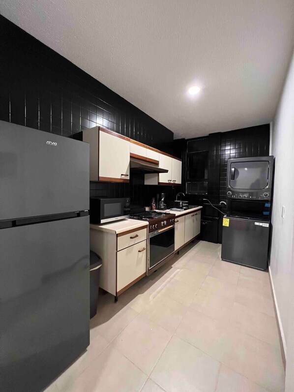 You'll find a stacked washer & dryer in the kitchen