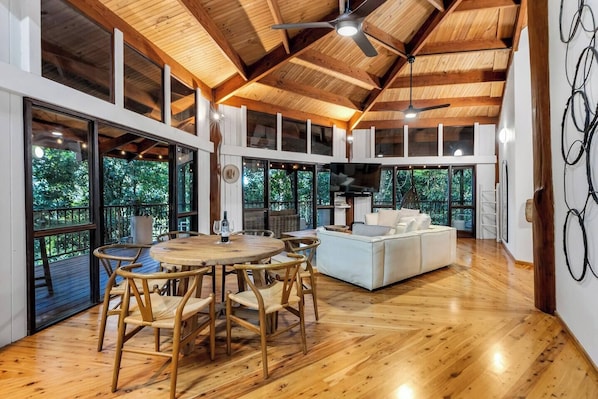 Come together around the round dining table within the open-plan living space opening to the large balcony. 
