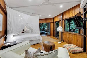The primary suite encompasses the entire lower level featuring a king-size bed, a kitchenette, and an ensuite bathroom.