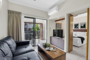 Sliding doors open to an all-weather balcony, creating a seamless indoor-outdoor flow ideal for alfresco dining and enjoying the tropical breeze.