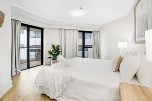 Retreat to the primary bedroom, where a plush king-size bed awaits to ensure a restful night's sleep after a day of exploration.
