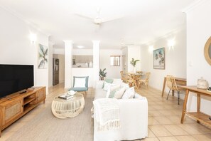 The open-flow design allows natural light to flood in, creating a perfect spot to unwind after a day at the beach.

