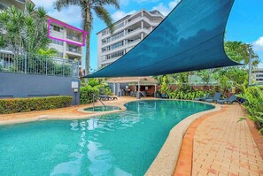 Dive into relaxation and soak up the sun in the inviting shared swimming pool.

