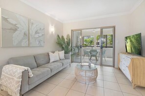 Perfect for relaxation or entertainment, this space seamlessly connects to the private balcony overlooking the resort pool. 